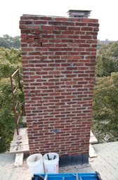 A historic brick chimney in very bad shape
