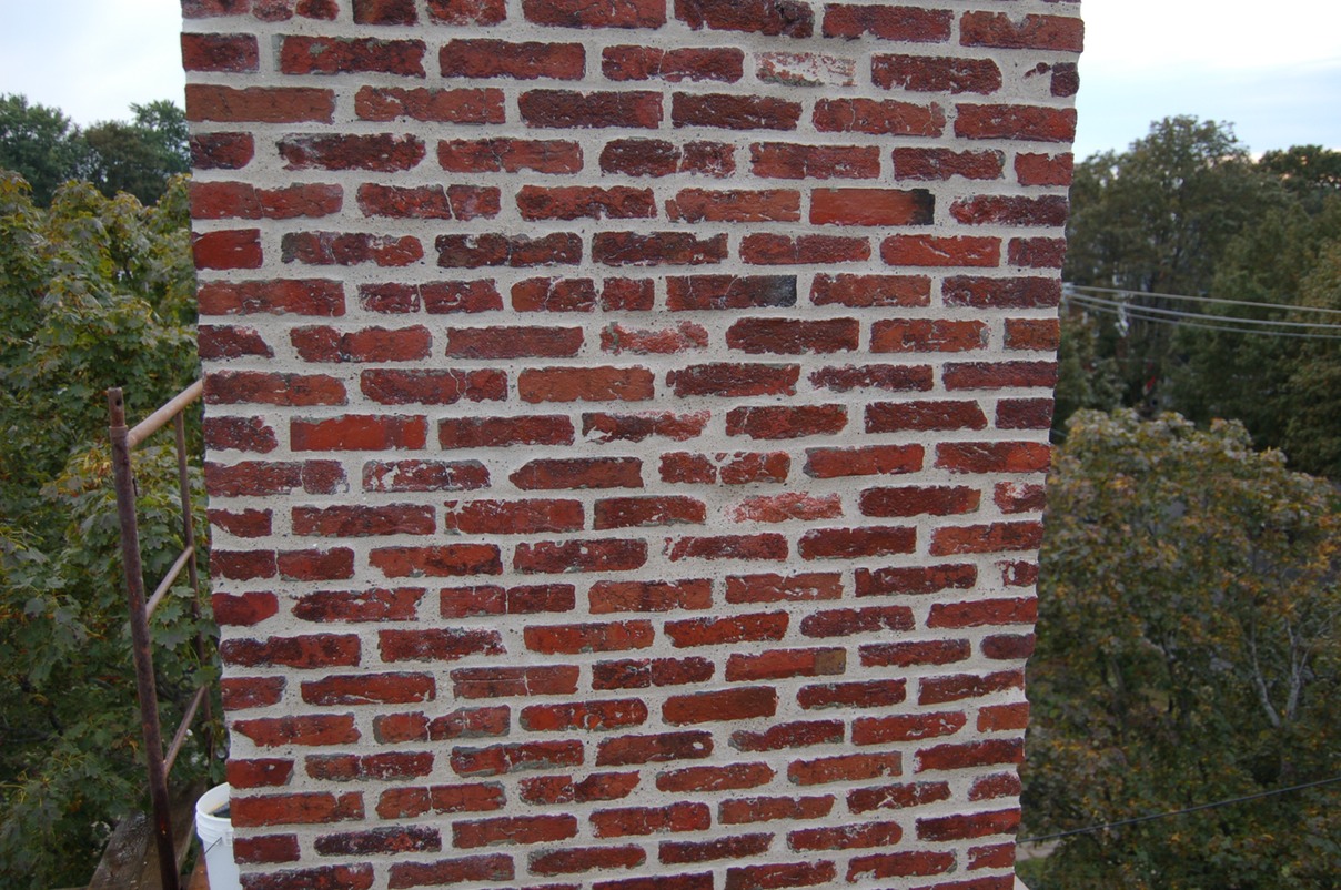 Brick repointed and voids filled with lime mortar