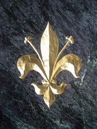 Carved fleur de lis with gold leaf